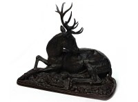 Lot 1703 - BRONZE SCULPTURE OF A STAG modelled recumbent,...